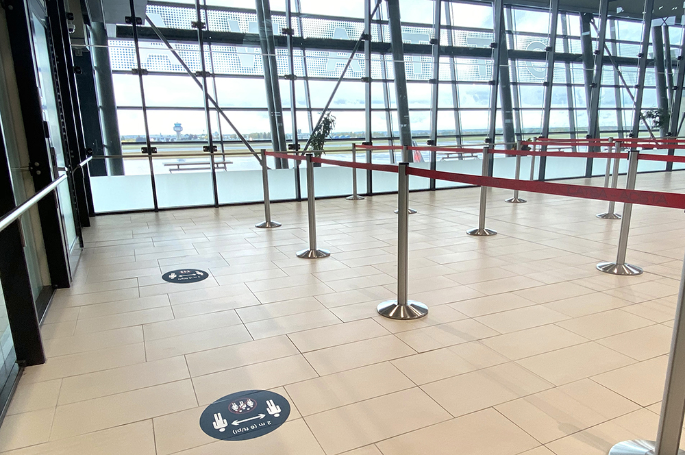 queuing area before entering screening area with view of airfield and control tower