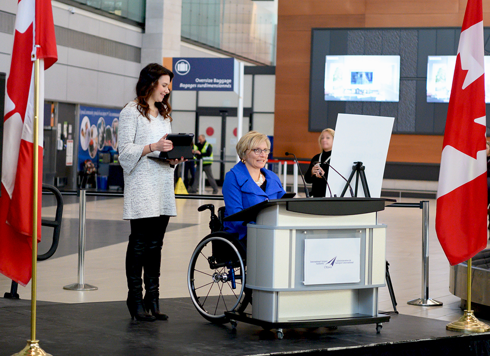 Samantha Proulx and Julie Sawchuk at podium in the Arrivals area at the Ottawa Airportors Inc.